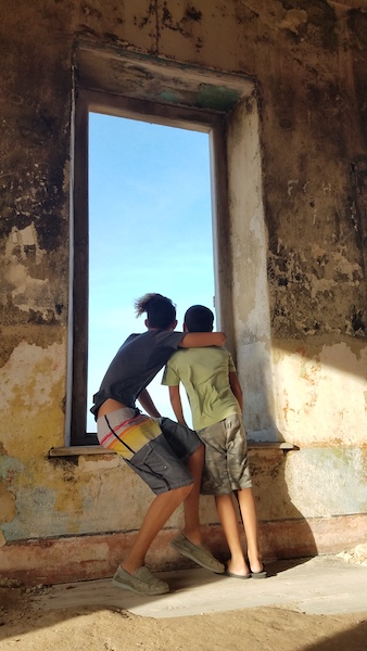 Kyle and Max looking out of the north window on the lighthouse of Klien Curacao